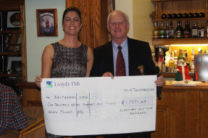 Jo accepting cheque from Richard, Captain of Llanishen Golf Club
